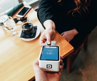person holding credit card swipe machine