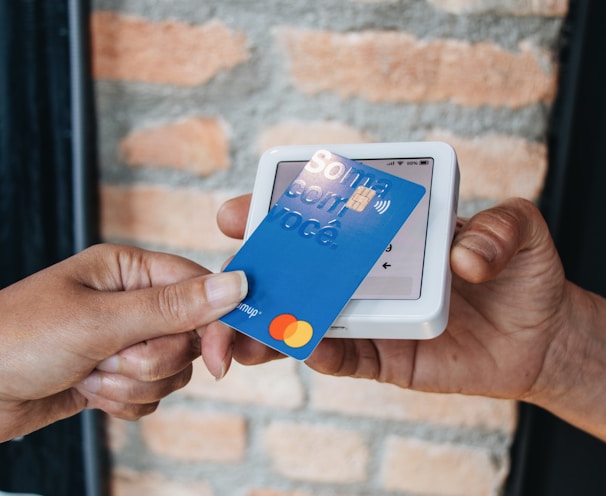 a person handing a credit card to another person