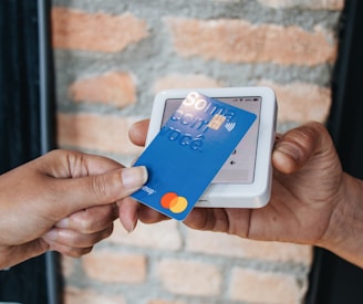 a person handing a credit card to another person