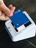 a person holding a credit card in their hand
