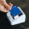 a person holding a credit card in their hand